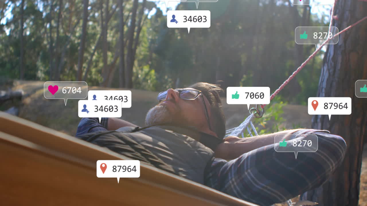Man reclining hammock in forest animated social media icons floating around, illustrating marketing