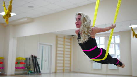 anti-gravity instructor on the canvas flying over the floor in the white room