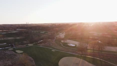 4k drone sunset fly over of rural golf course