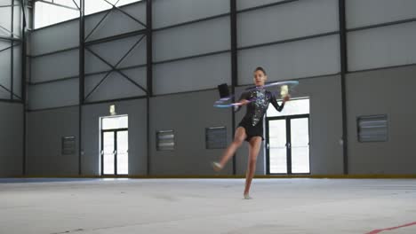 female gymnast performing at sports hall