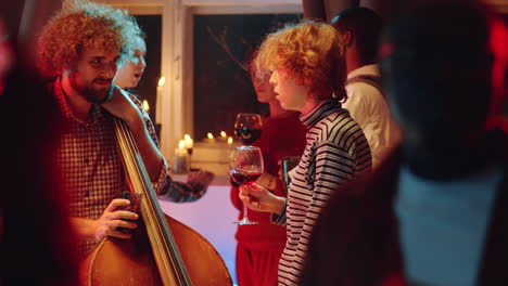 musician talking with woman on concert afterparty