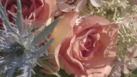 close-up, panning shot of a beautiful bouquet of roses and colorful flowers