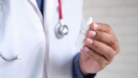 doctor holding eye drops