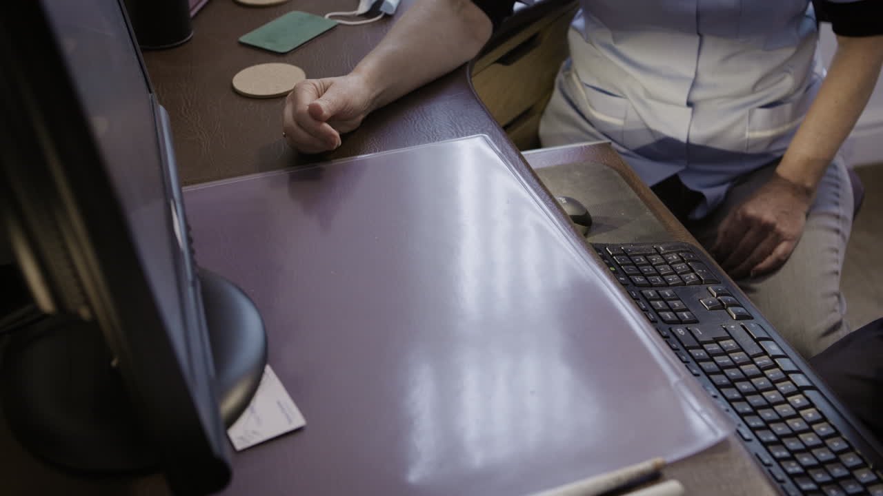 Nurse and Elderly Man at Clinic