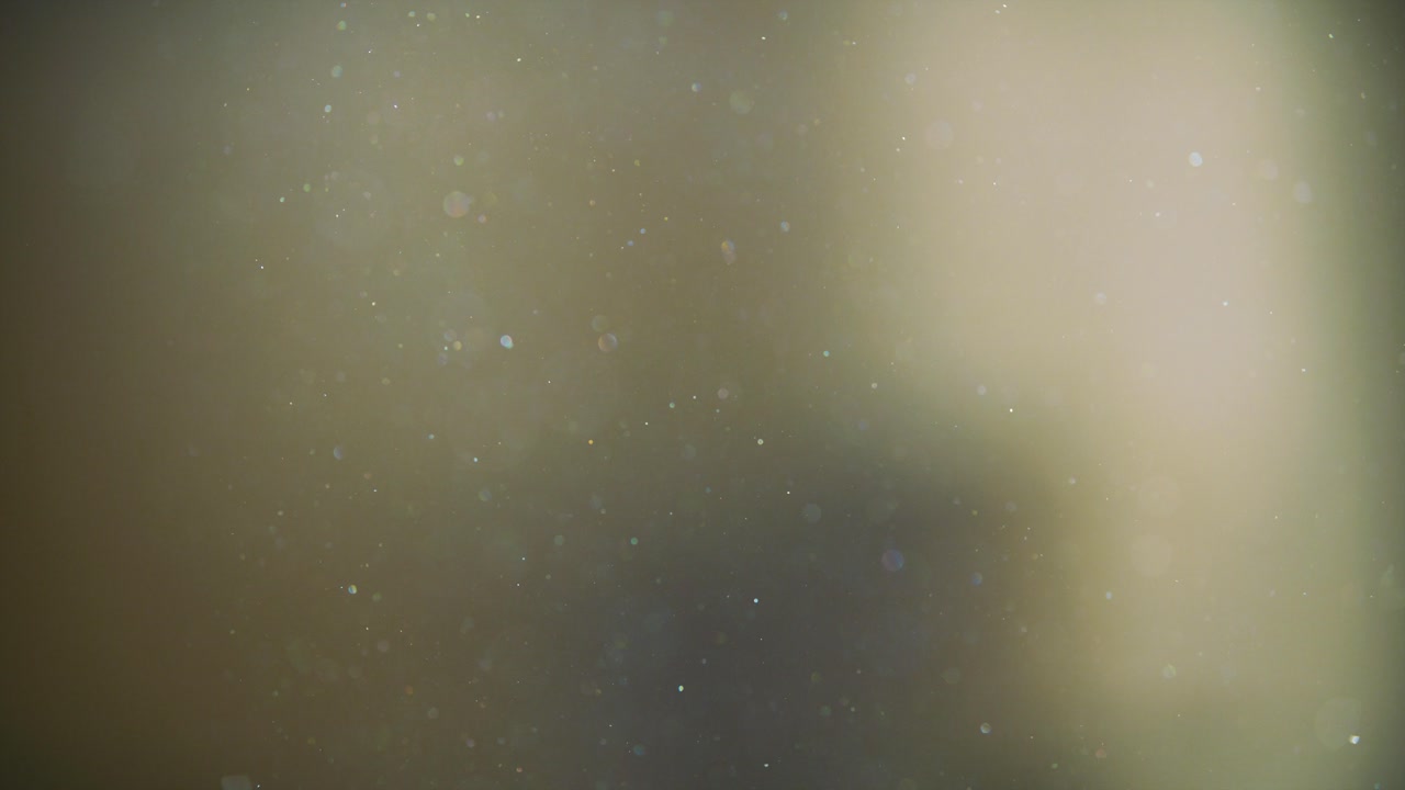 esferas de polvo multicolores flotando pacíficamente, cámara lenta 4k