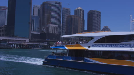a manly ferry pulls out of circluar quay in sydney australia