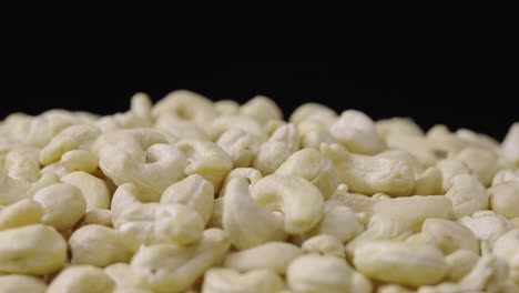 close-up of cashew nuts on a black background