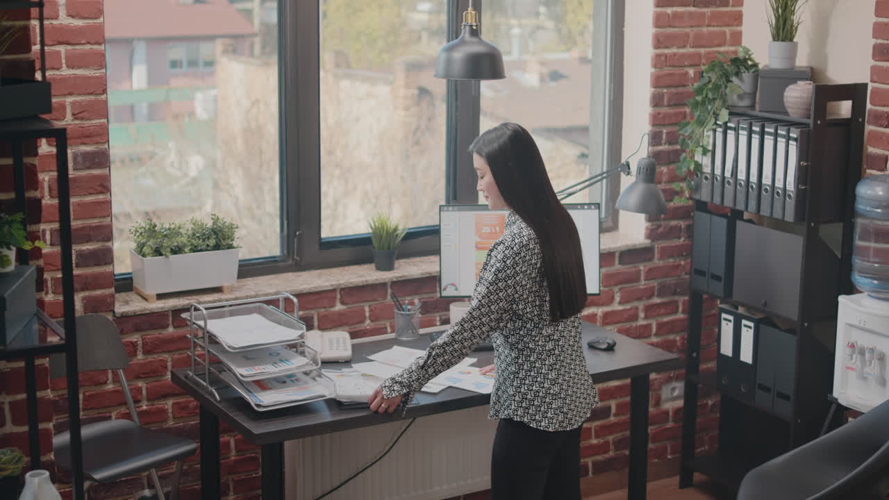 Asian woman working on business project with papers
