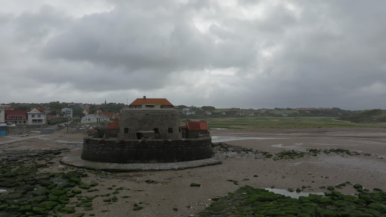 Orbit around Fort d'Ambleteuse revealing the small coastal village Ambleteuse during a stormy day