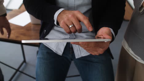 male hands holding a tablet