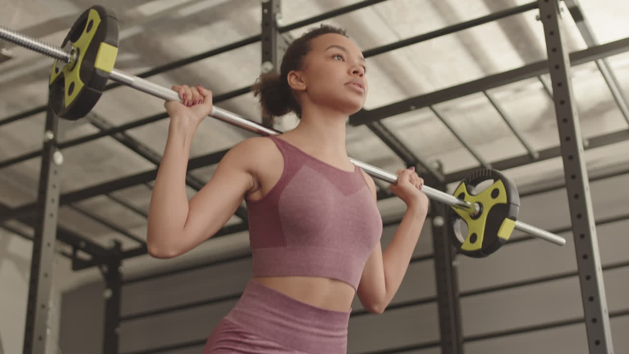 Mixed-Race Athlete Doing Squats with Barbell