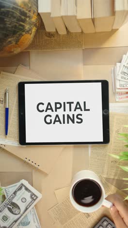 vertical video of capital gains displaying on finance tablet screen