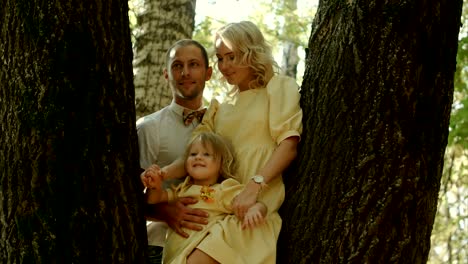 happy family in golden maple autumn park