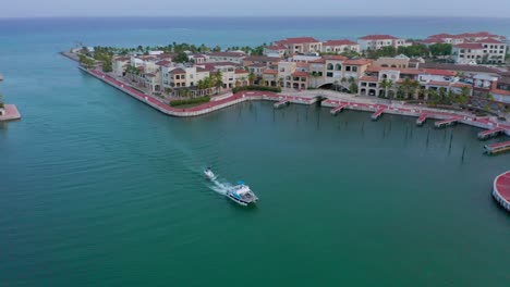 catamaran orbit shot highlighting small boat entering the cap cana marina