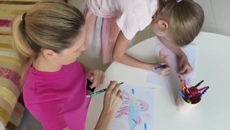 mother and daughter drawing together