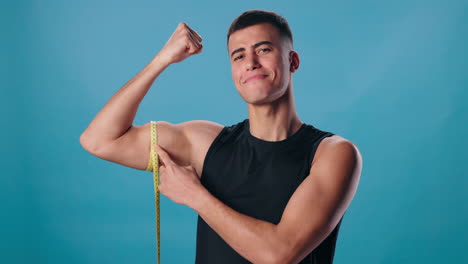 man measuring his biceps with a tape measure
