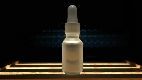 dramatic light stars behind generic unlabelled beauty cosmetic skin care product bottle oil with dropper white and cinematic
