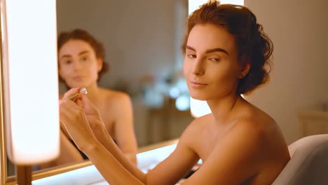 woman getting ready in front of a mirror