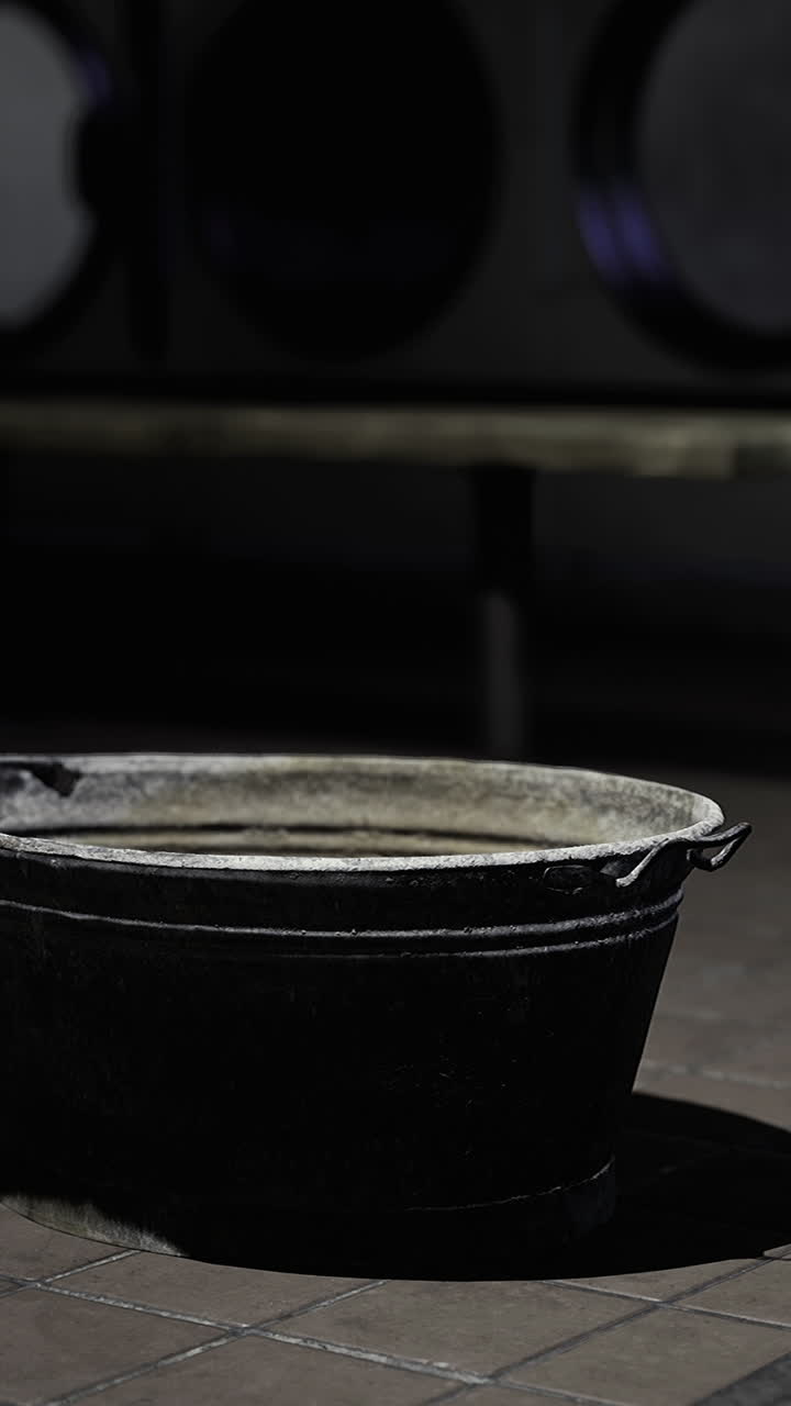 Old metal container sits quietly in a dimly lit room during evening hours