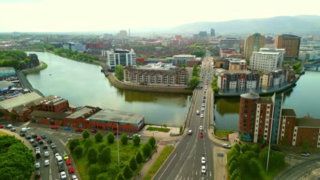 angled advancing aerial video of queen's bridge, the passing traffic and the river liffey in belfast, northern ireland in the uk. produced in 4k, 60 frames per second and with rec709 color.