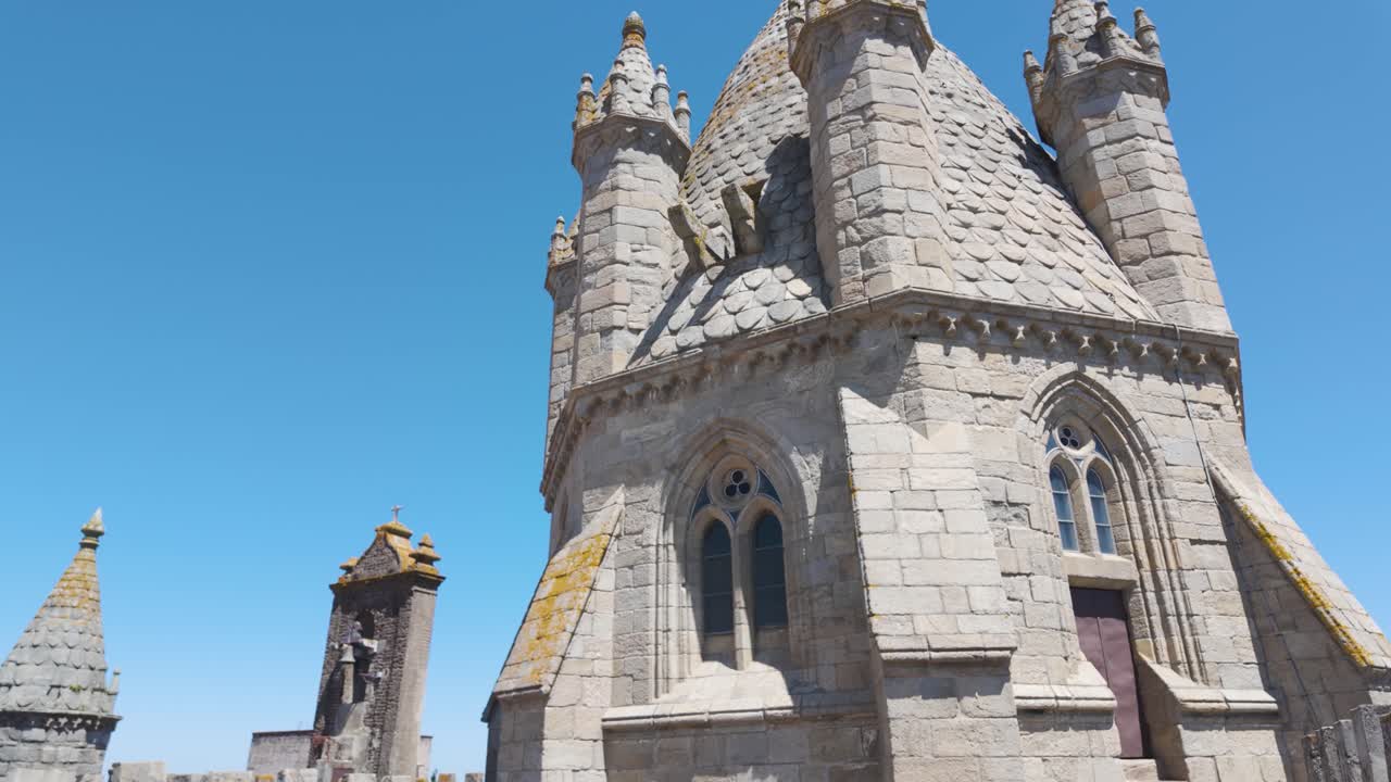 Architectural details of the Cathedral of Evora, a gothic style building in Evora, Portugal, under a summer blue sky