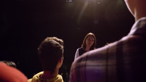 teenagers rehearsing in a theatre