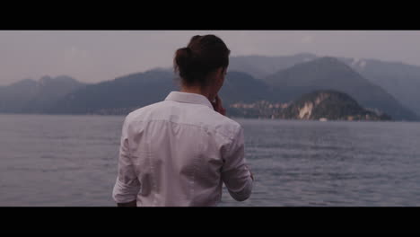 man contemplating a lakeside view