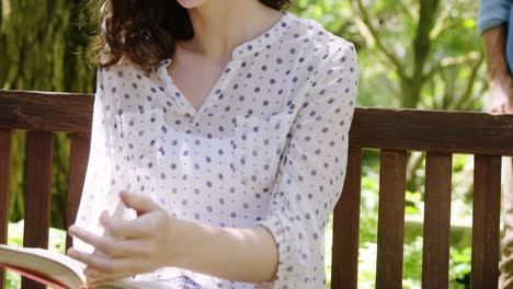 beautiful woman reading book in park