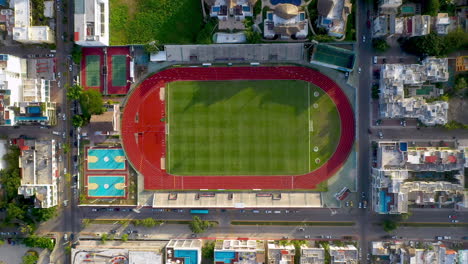 rising drone shot of sports field in the city of playa del carmen mexico