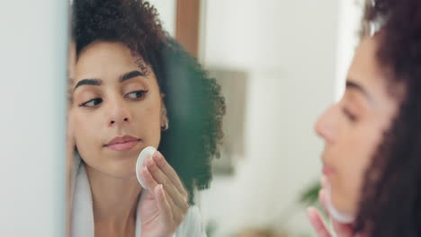 woman cleansing face in bathroom