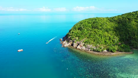 Boats-sailing-on-calm-blue-turquoise-sea-water-around-beautiful-rocky-coastline-of-tropical-island-with-green-trees-forest-in-Philippines