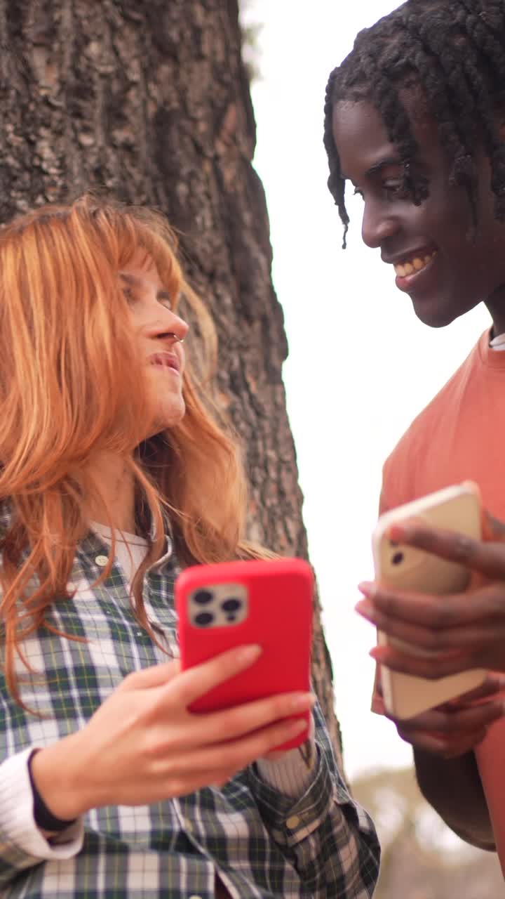 Young adults using cellphones outdoors