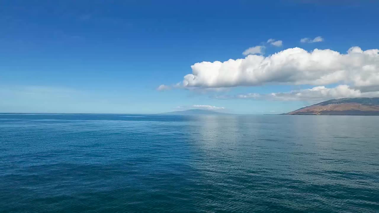 Over ocean from Kamaole Beach on Maui Hawaii toward Lanai Island, aerial view