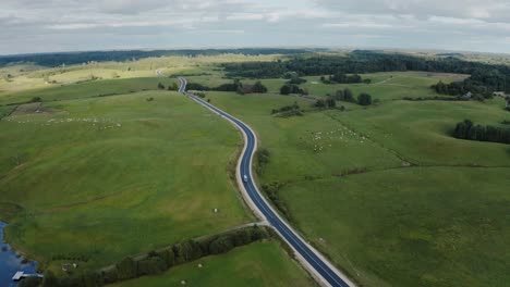 car driving on a scenic countryside road. aerial