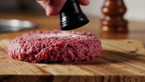 seasoning a hamburger patty