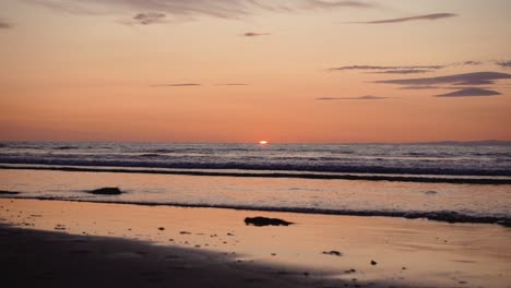 man running with guitar in back sand beach at sunset-25