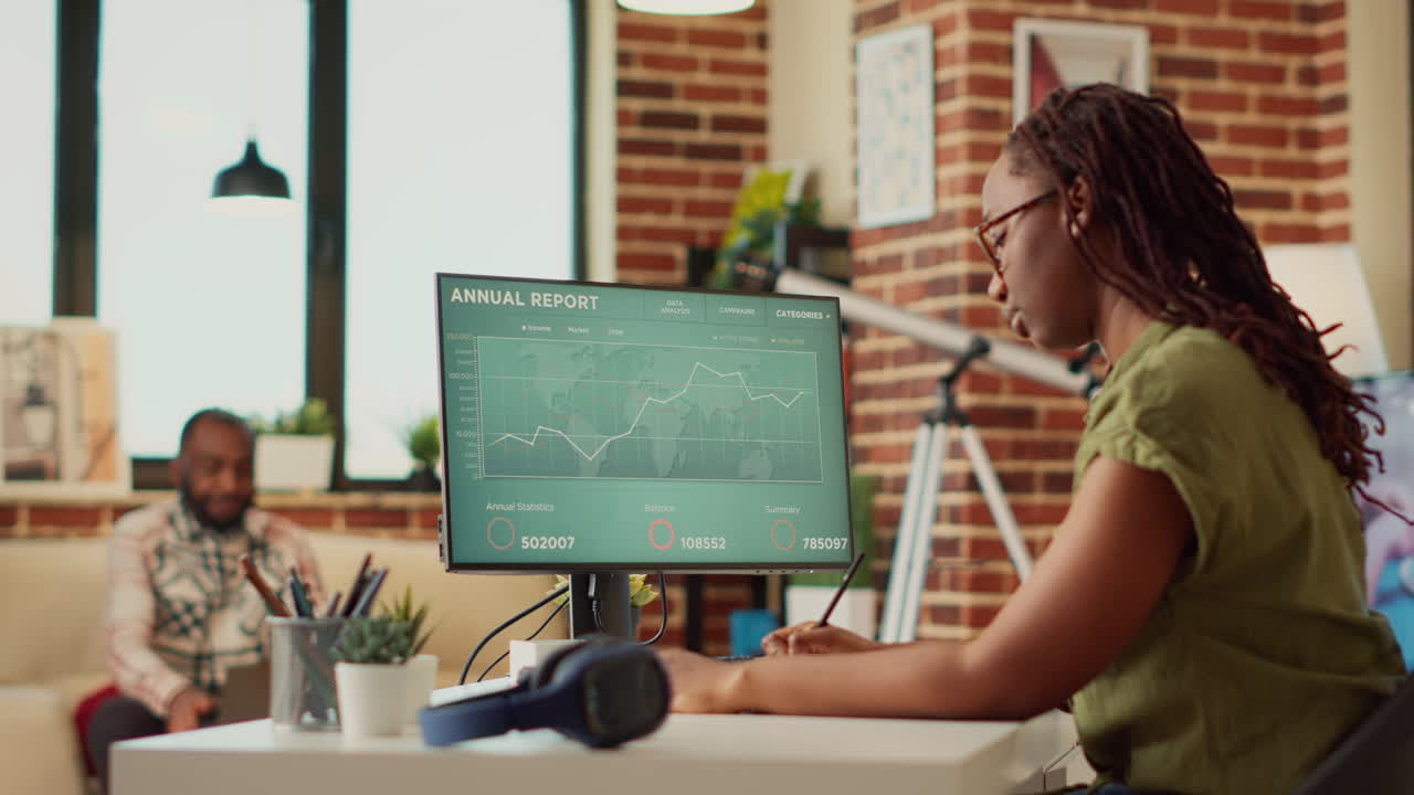Female employee analyzing financial report on data diagrams