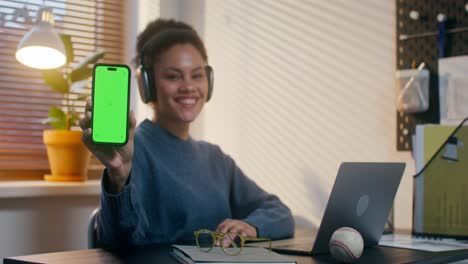 woman presenting green screen smartphone