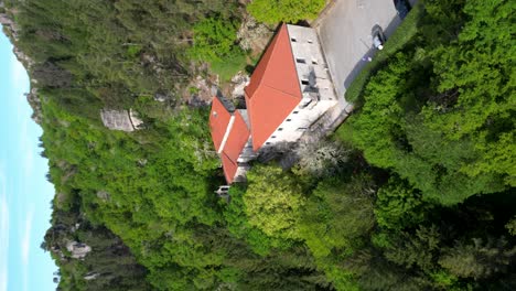 VERTICAL-DRONE-SHOT-monastery-of-san-pedro-of-rocas,-esgos,-ourense,-spain,-orbit-green-forest