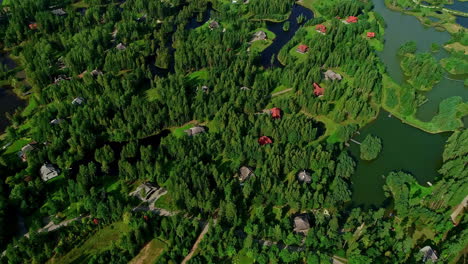 several detached houses between trees in wealthy village of amatciems, latvia