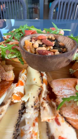 delicious charcuterie board with nuts, cheese, and bread