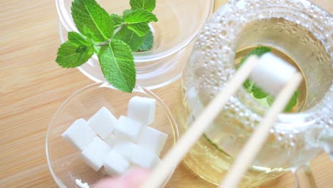 Adding-sugar-cubes-to-mint-tea