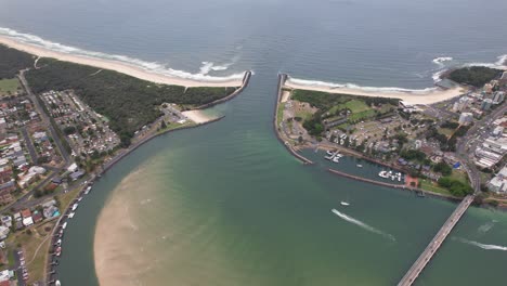 coolongolook river mouth between forster and tuncurry in new south wales, australia. aerial sideways shot