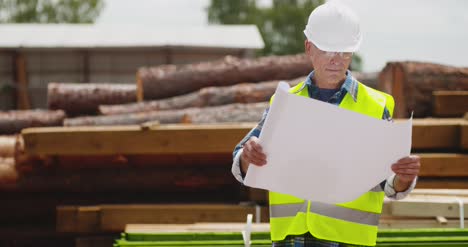 engineer explaining while holding blueprint 3