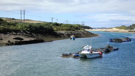 white boat anchored in hayle town port, blue water, cornwall, england