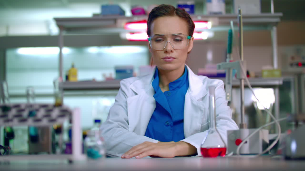Woman researcher wear safety glasses in lab. Female researcher wearing glasses