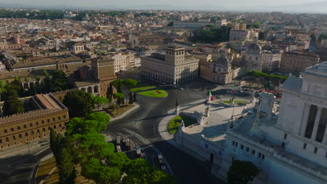 Amazing-aerial-slide-and-pan-footage-of-Piazza-Venezia-square-surrounded-by-historic-buildings.-Revealing-of-majestic-Vittoriano-monument-with-statues-of-goddess-Victoria.-Rome,-Italy