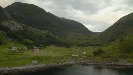 scenic view of mountains and small village in maloy, vestland county, norway - aerial drone shot