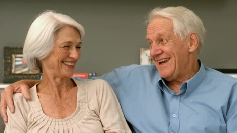 Elderly-couple-laughing-in-their-home