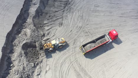 aerial view loading bulldozer in open air quarry